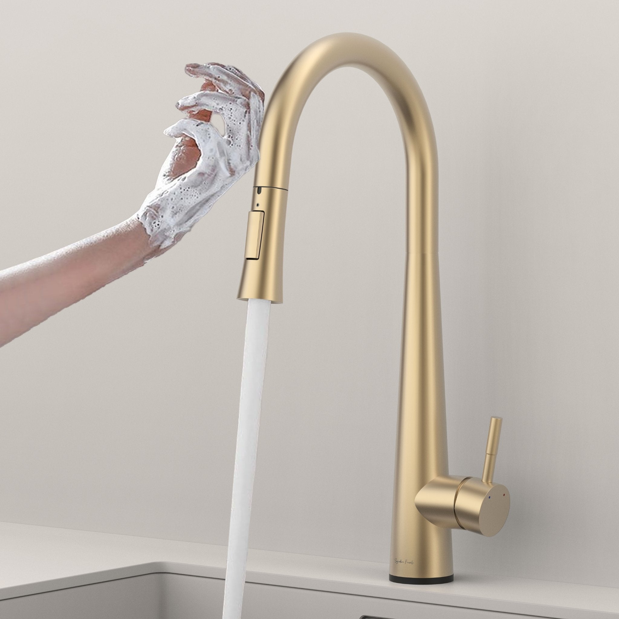 Brushed gold touch kitchen faucet activated by a soapy hand with water flowing #color_brushed gold
