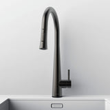 Front view of Arcus Touch Kitchen Faucet with Pull-Down Sprayer in gunmetal gray finish, installed on stainless steel sink by Signature Faucets. #color_gunmetal gray