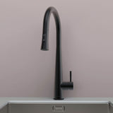 Front view of Arcus Touch Kitchen Faucet with Pull-Down Sprayer in matte black finish, installed on stainless steel sink by Signature Faucets. #color_matte black