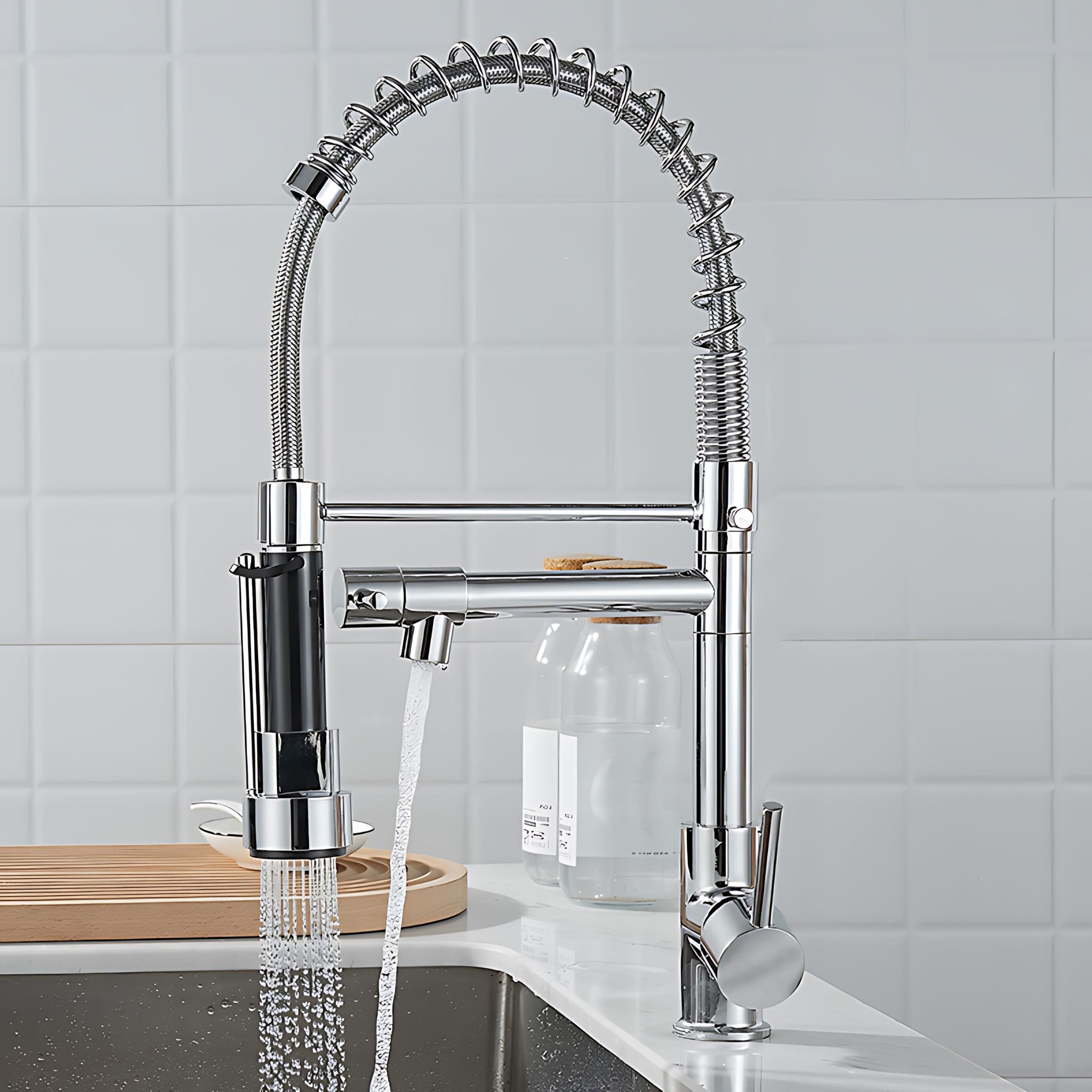 Chrome kitchen faucet with a pull-down sprayer on a kitchen counter. #color_chrome