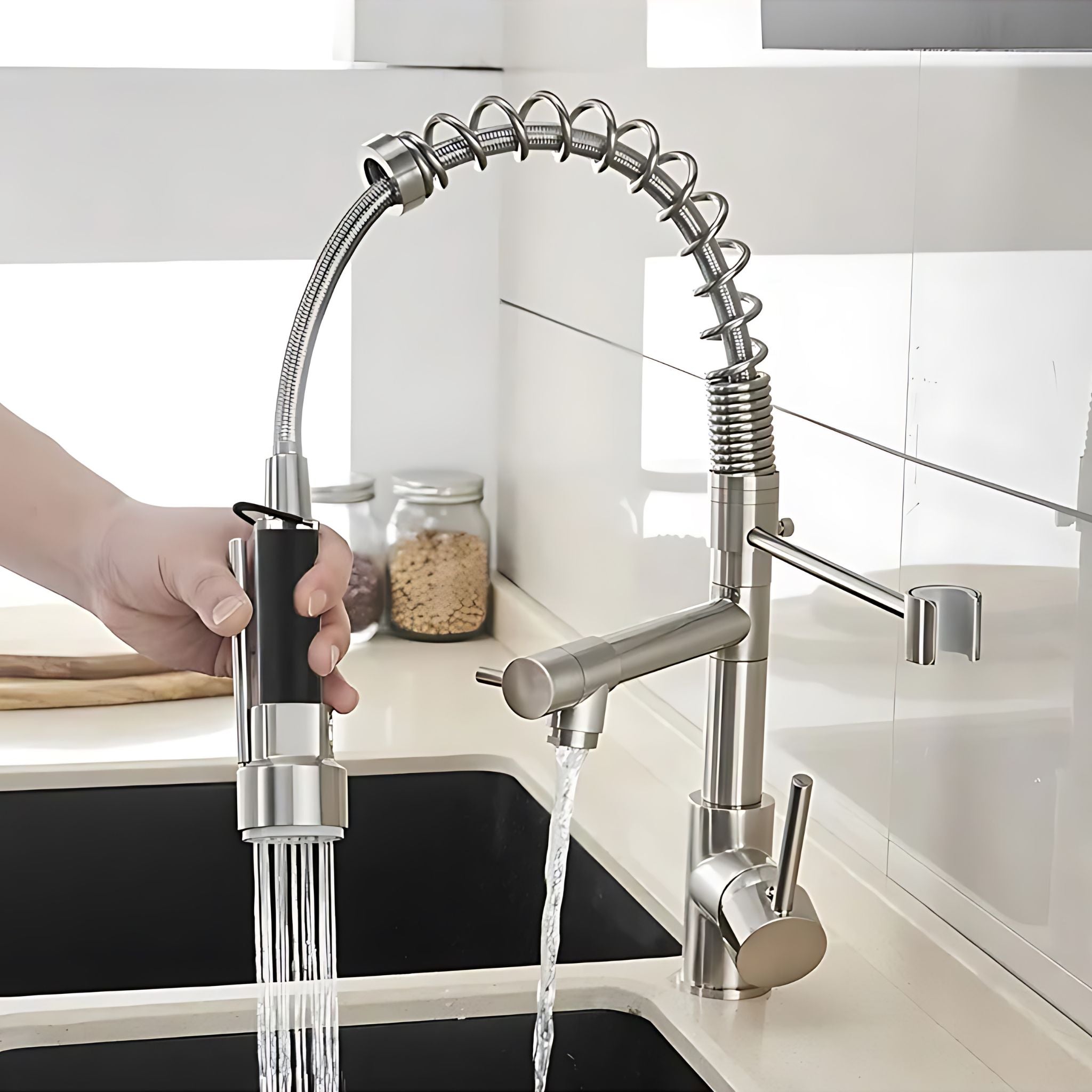 Brushed Nickel pull-down kitchen faucet demonstrating flexible spring hose reach into deep sink #color_brushed nickel