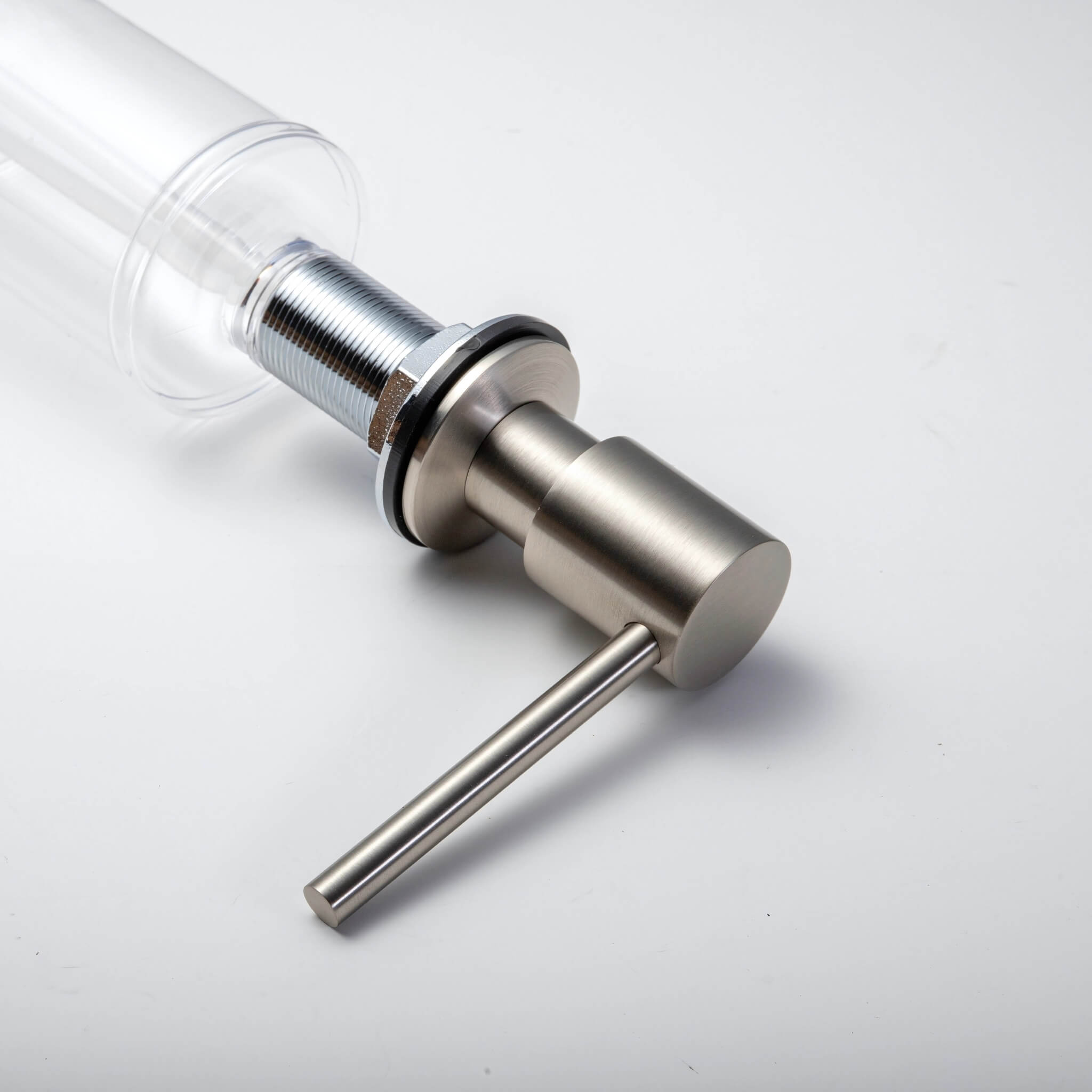 A stainless steel kitchen sink soap dispenser with a clear container and a brushed nickel finish