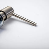 A stainless steel kitchen sink soap dispenser with a clear container and a brushed nickel finish