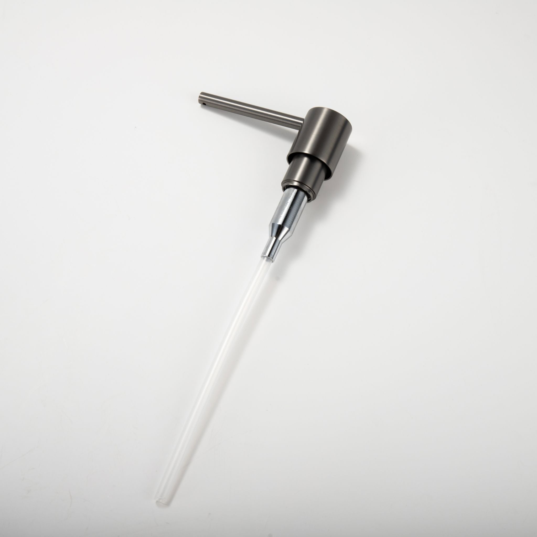 Detail view of the Berg Kitchen Soap Dispenser pump mechanism and connection to the bottle straw in Gunmetal Gray finish.