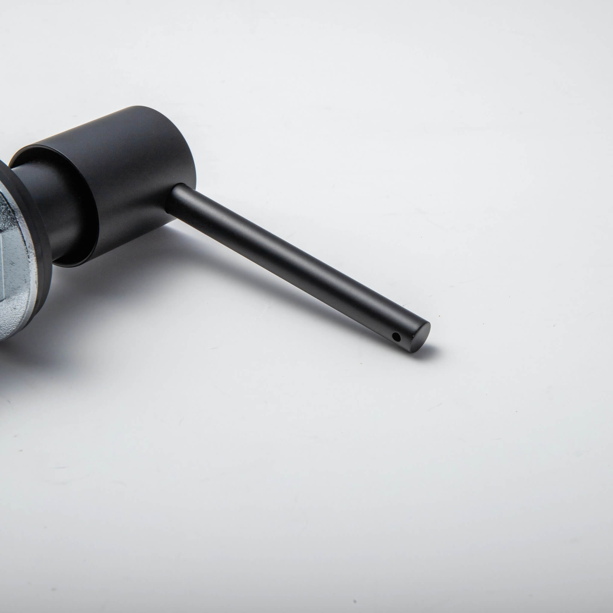 A stainless steel kitchen sink soap dispenser with a clear container and a matte black finish