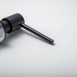 A stainless steel kitchen sink soap dispenser with a clear container and a matte black finish