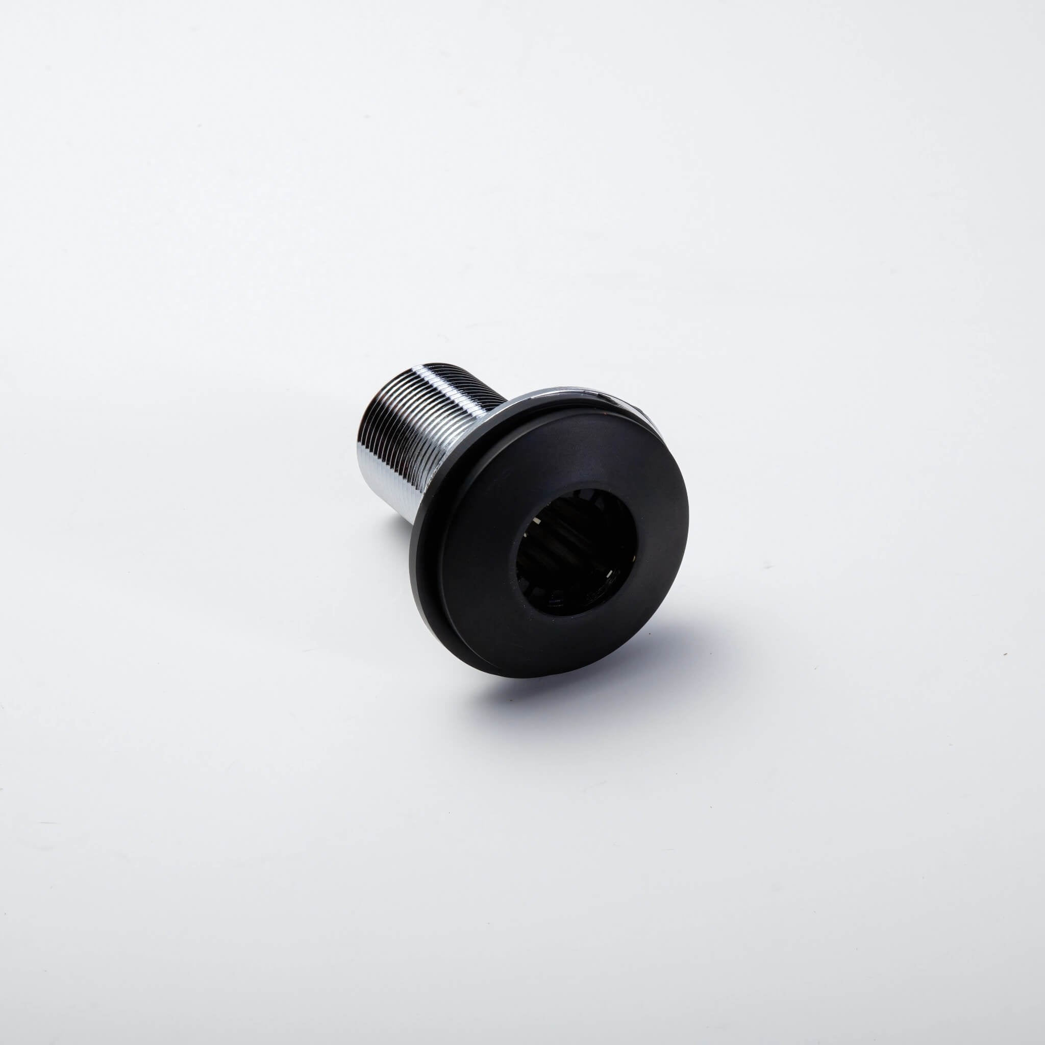 Metallic bolt with black threaded end on white background