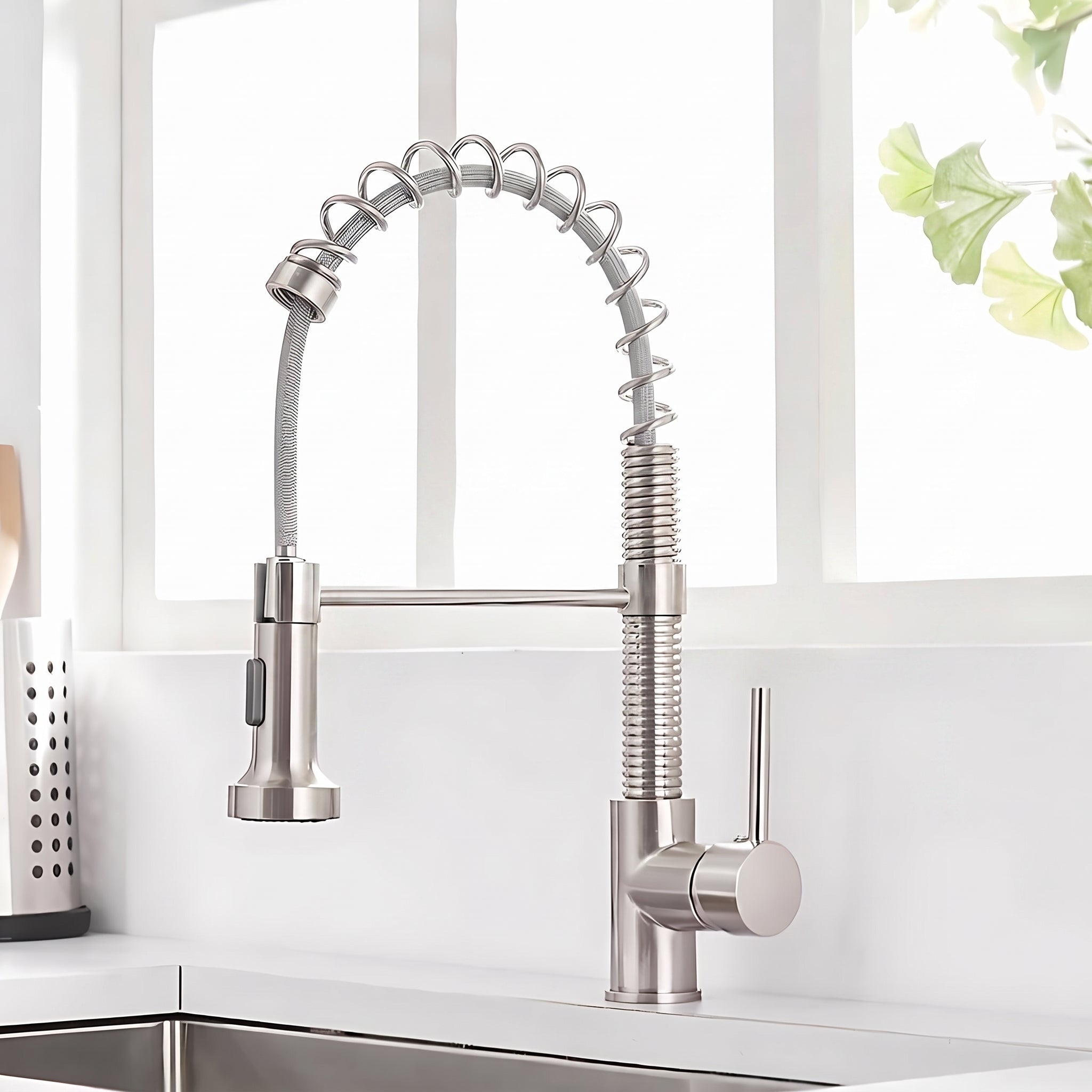 Spiro v2.0 brushed nickel spring spout kitchen faucet installed on a countertop beside a bright kitchen window #color_brushed nickel