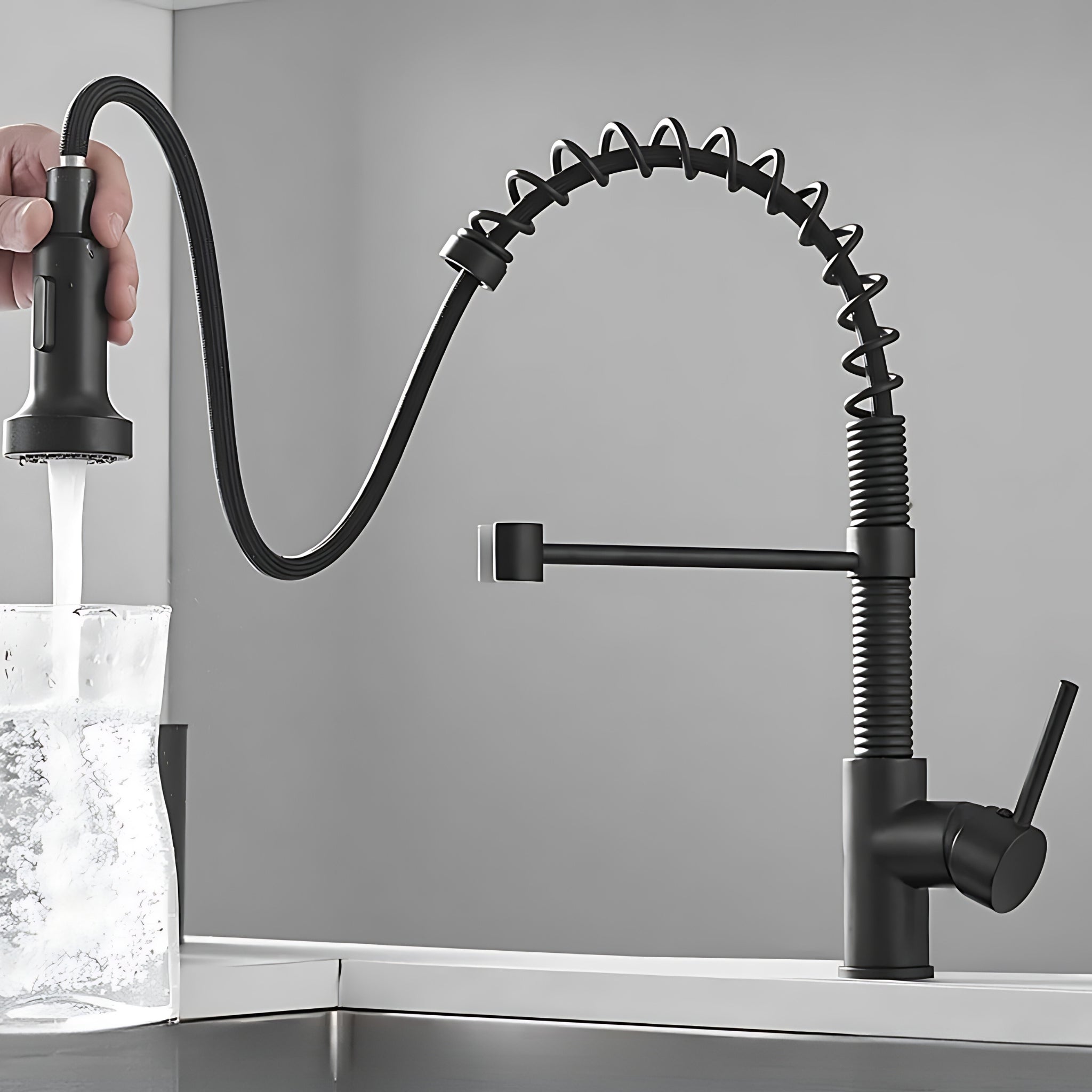 Spiro v2.0 matte black kitchen faucet sprayer head held out on the hose, filling a glass in stream mode #color_matte black