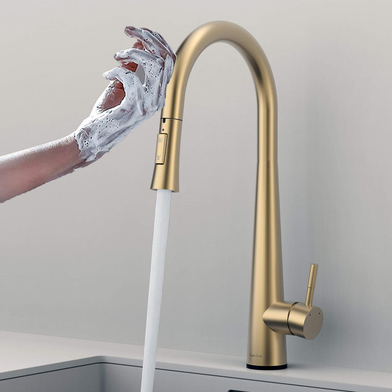 Touch-activated Arcus Kitchen Faucet with Pull-Down Sprayer in brushed gold finish — hands-free operation shown as soapy hands activate water flow by Signature Faucets. #color_brushed gold