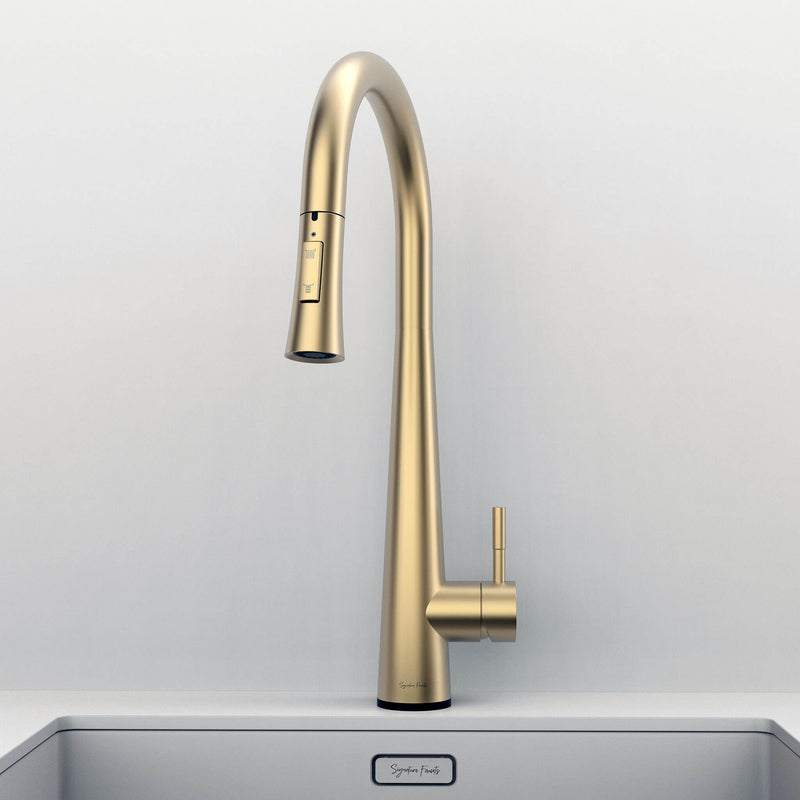 Front view of Arcus Touch Kitchen Faucet with Pull-Down Sprayer in brushed gold finish, installed on stainless steel sink by Signature Faucets. #color_brushed gold
