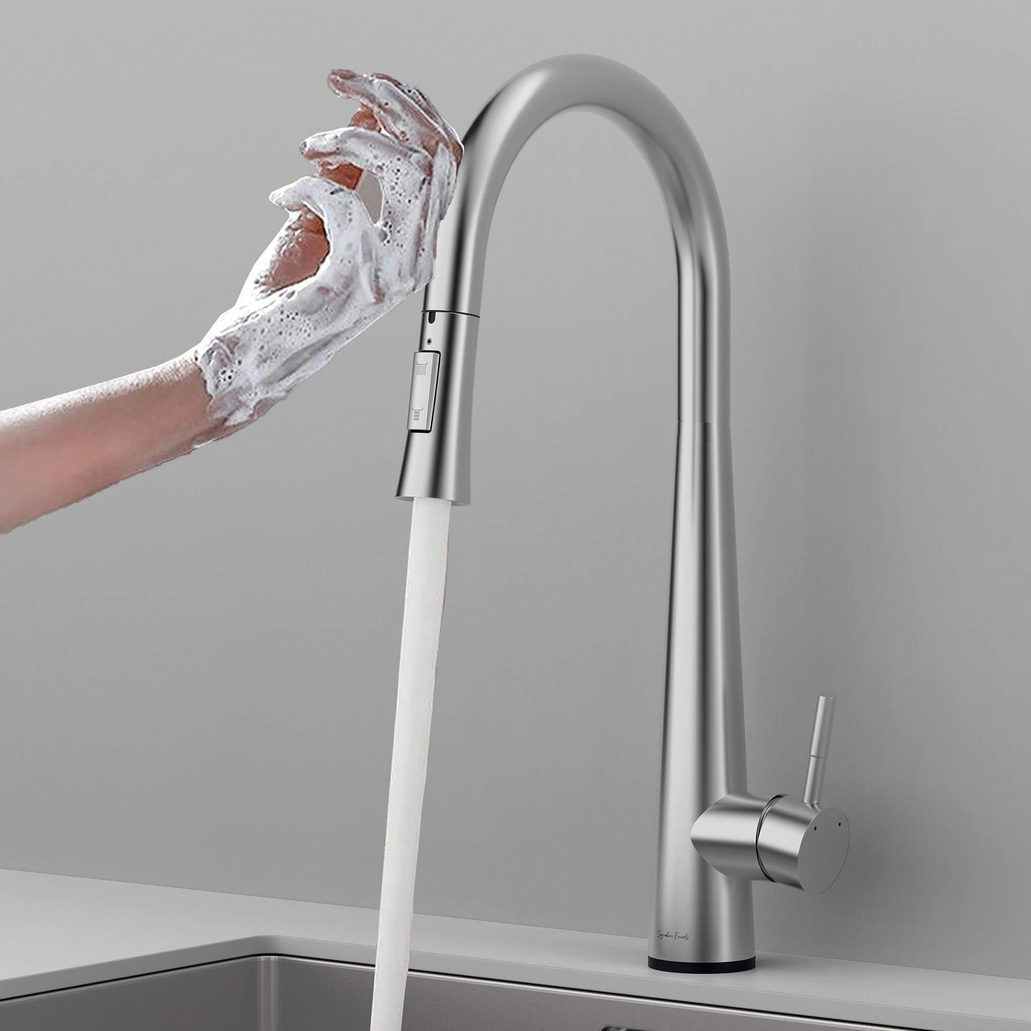 Hands covered in soap being washed under the Arcus Touch Kitchen Faucet with Pull-Down Sprayer in brushed nickel finish — modern touch-activated faucet design by Signature Faucets. #color_brushed nickel