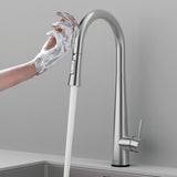 Hands covered in soap being washed under the Arcus Touch Kitchen Faucet with Pull-Down Sprayer in brushed nickel finish — modern touch-activated faucet design by Signature Faucets. #color_brushed nickel