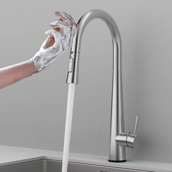 Hands covered in soap being washed under the Arcus Touch Kitchen Faucet with Pull-Down Sprayer in brushed nickel finish — modern touch-activated faucet design by Signature Faucets. #color_brushed nickel
