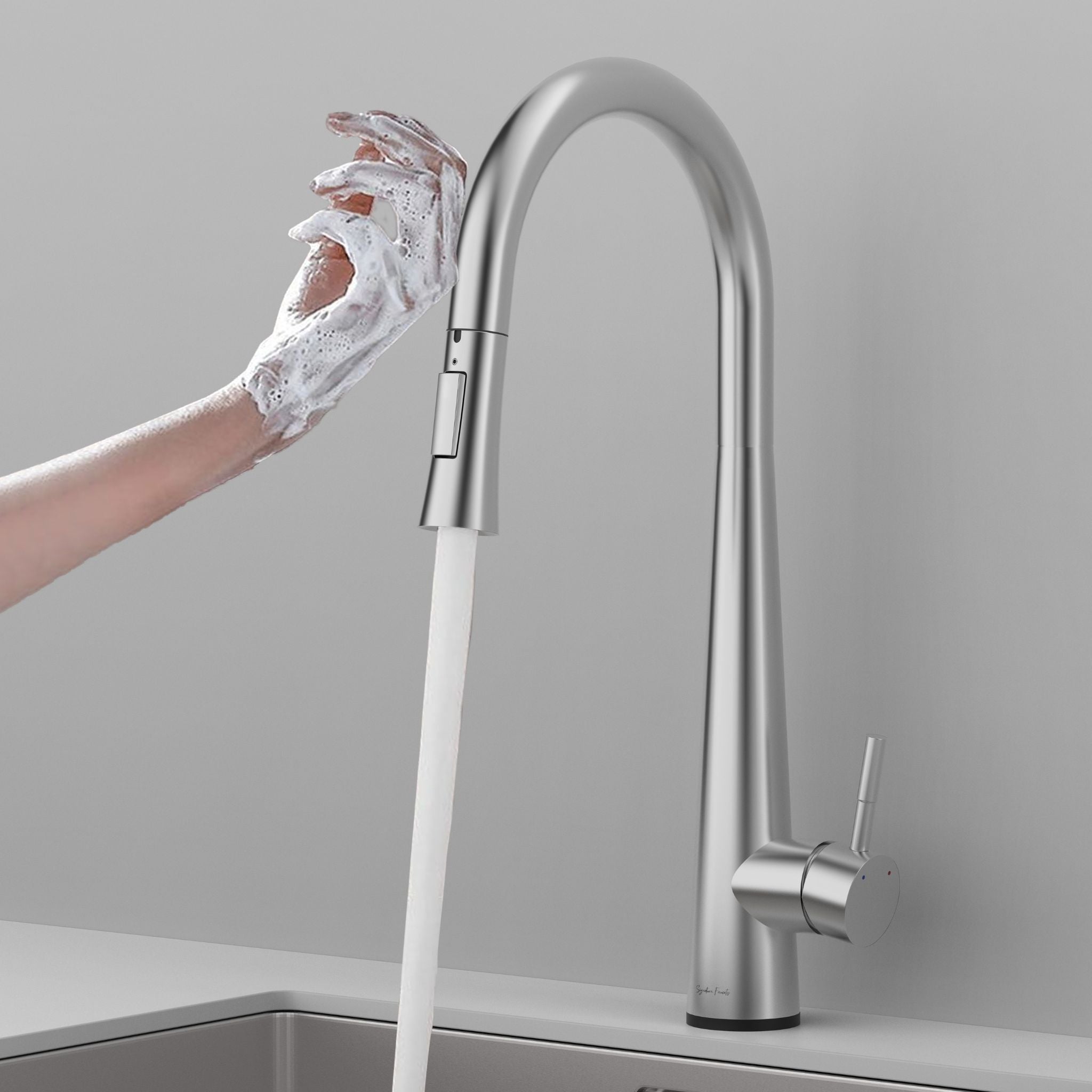 Brushed nickel touch kitchen faucet activated by a soapy hand with water flowing #color_brushed nickel