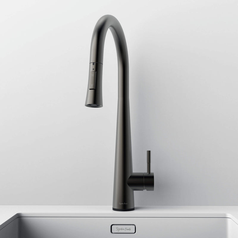 Front view of Arcus Touch Kitchen Faucet with Pull-Down Sprayer in gunmetal gray finish, installed on stainless steel sink by Signature Faucets. #color_gunmetal gray
