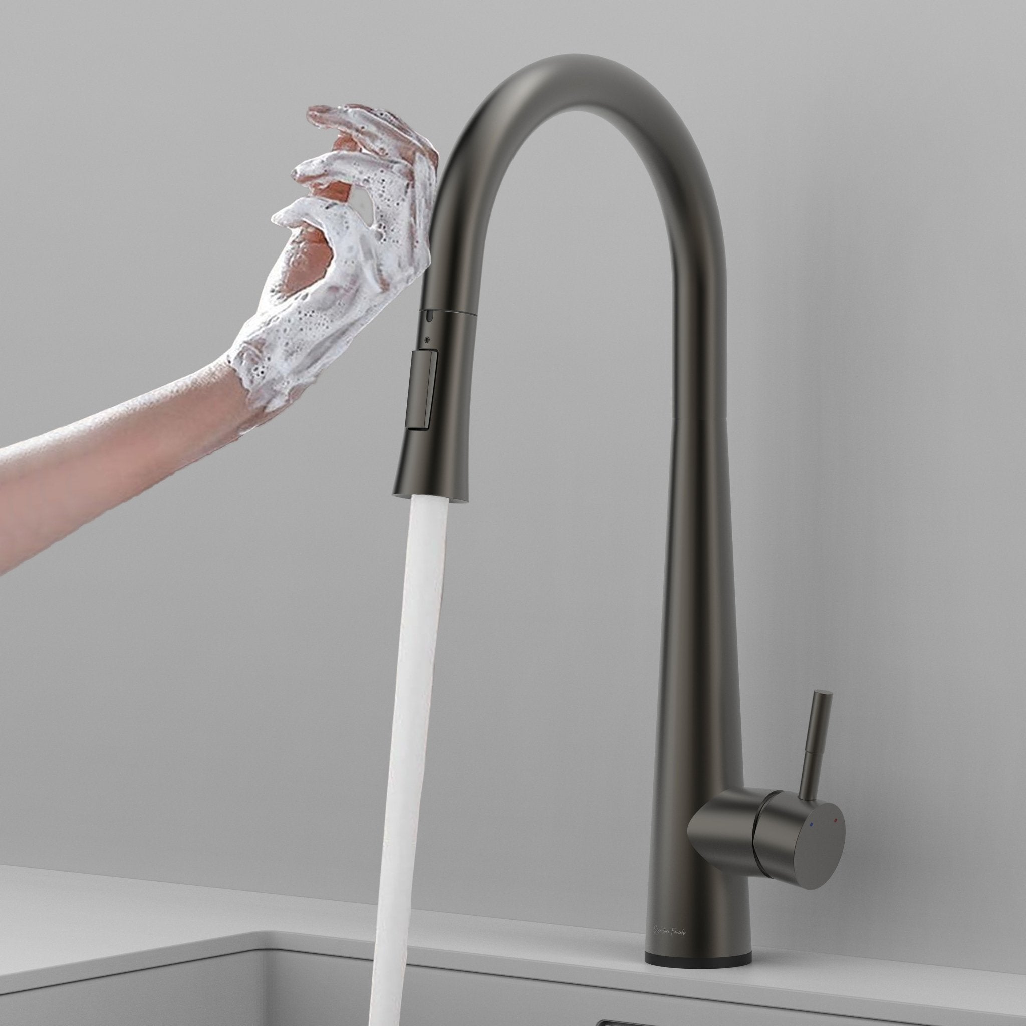 Gunmetal gray touch kitchen faucet activated by a soapy hand with water flowing #color_gunmetal gray