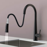 Arcus Touch Kitchen Faucet with flexible pull-down sprayer extended over sink, featuring matte black finish and ergonomic design by Signature Faucets. #color_matte black