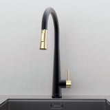 Front view of Arcus Touch Kitchen Faucet with Pull-Down Sprayer in Matte Black and Brushed Gold finish, installed on stainless steel sink by Signature Faucets. #color_matte black and brushed gold