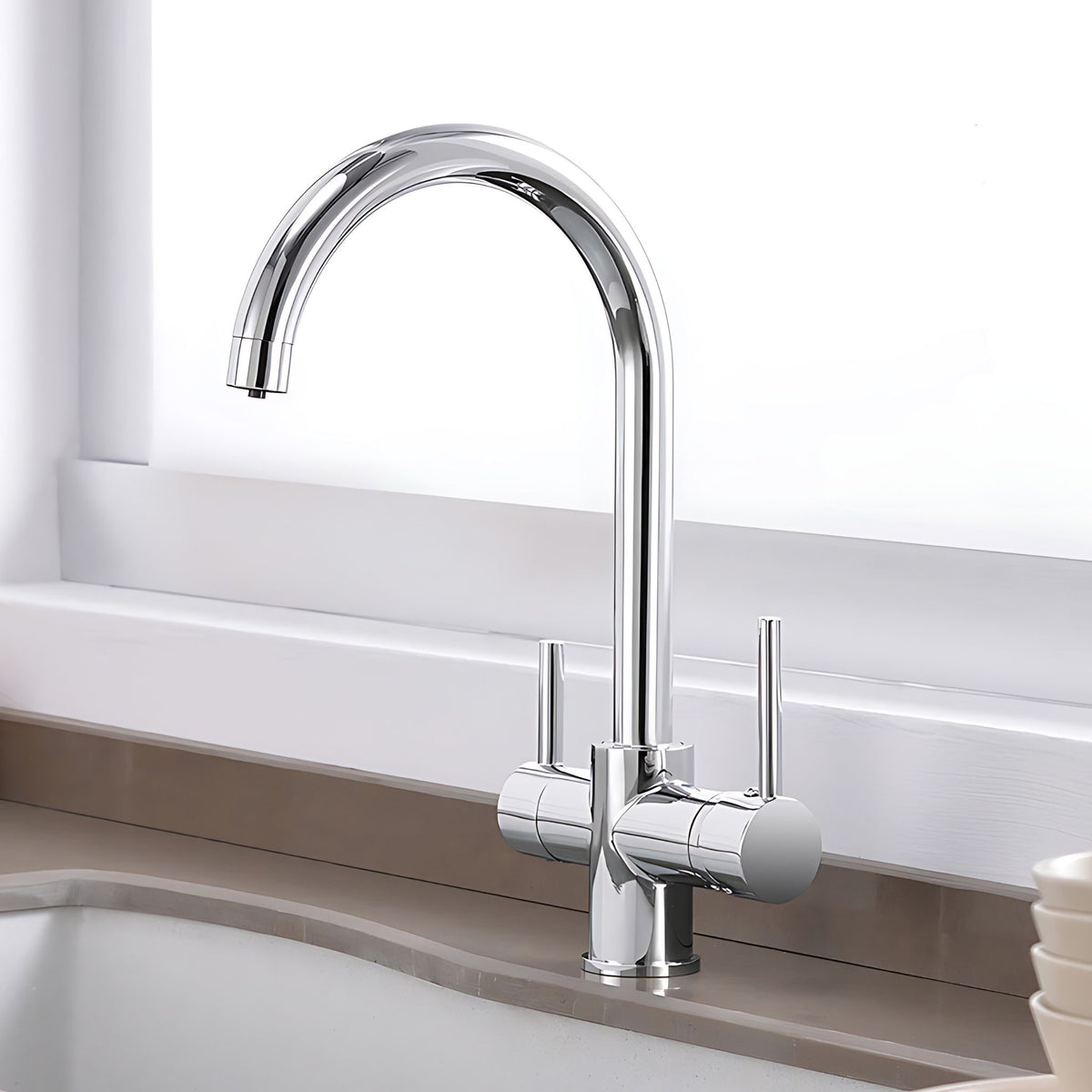A modern high-arc chrome kitchen faucet with two separate handles, installed on a countertop in a sink area. #color_chrome