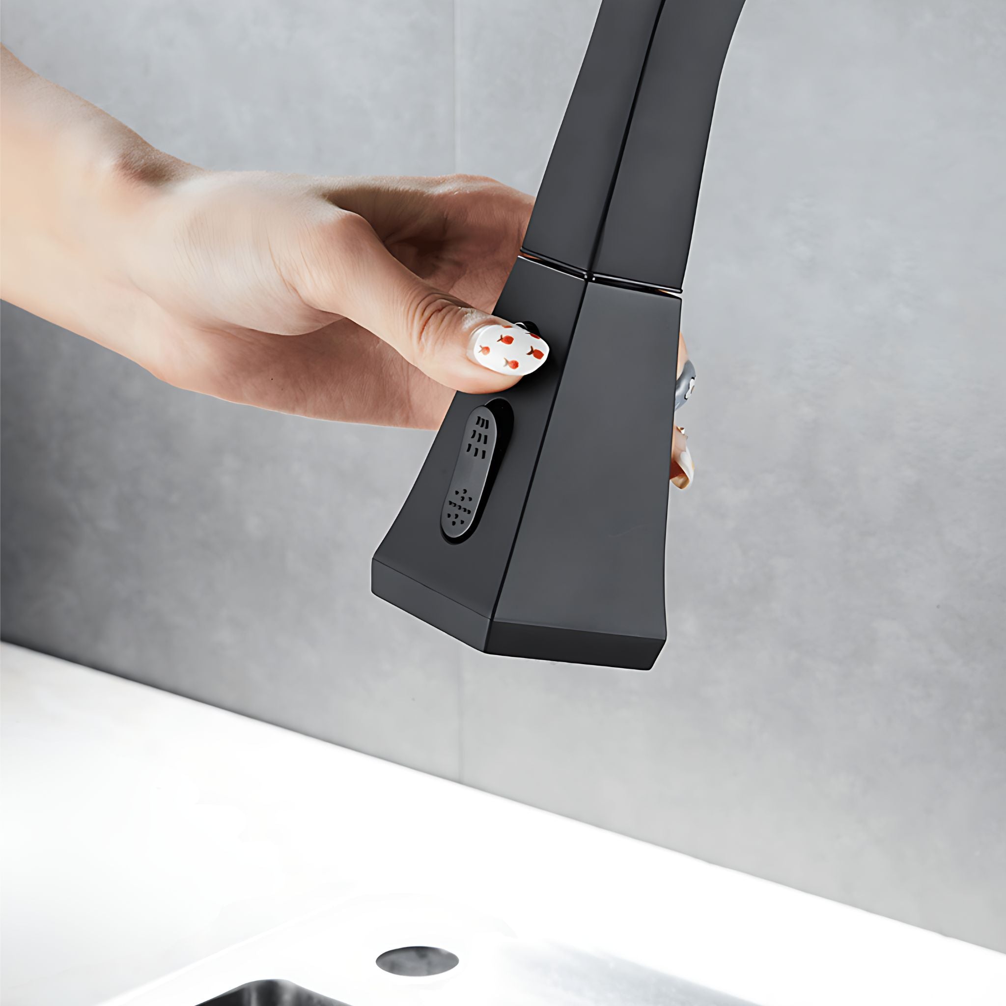 A hand with decorated nails is shown turning a matte black smart faucet handle. The faucet is positioned above a white sink against a gray tiled wall. #color_matte black