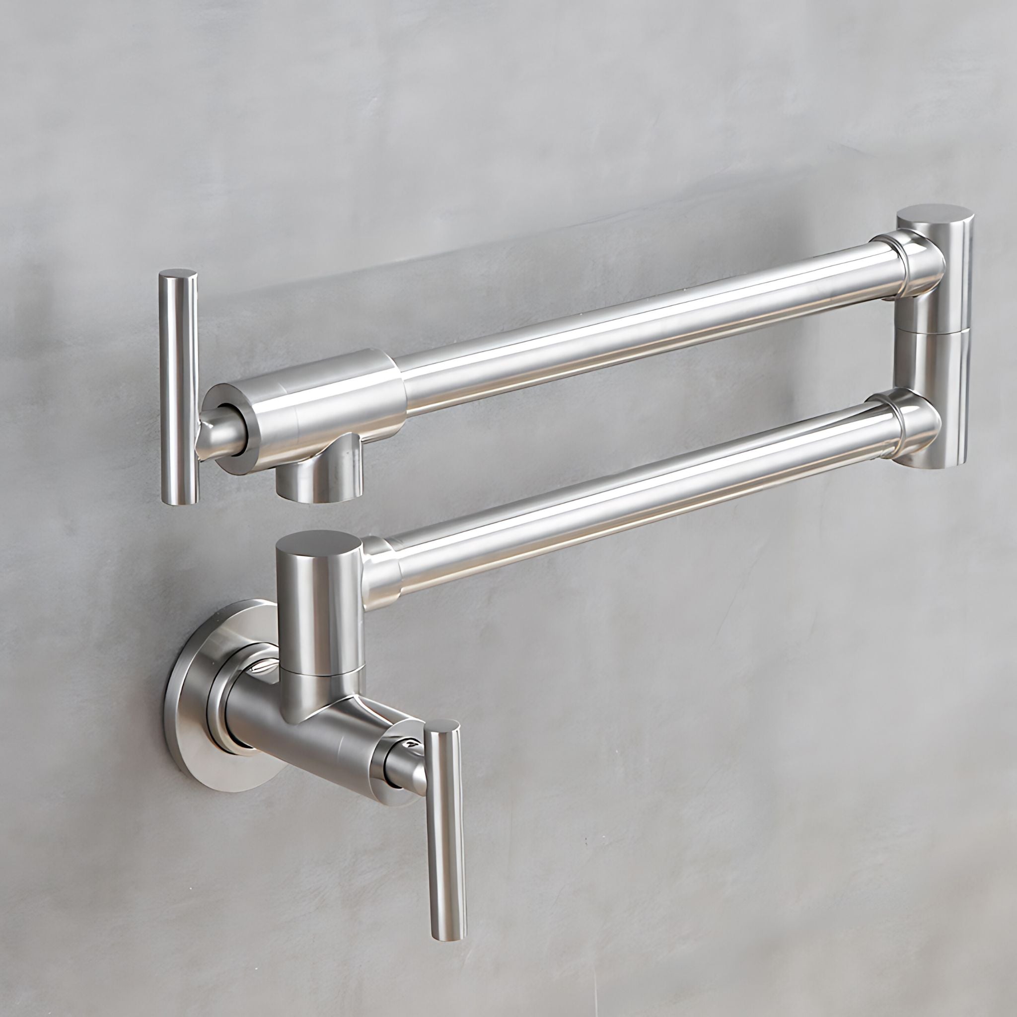 A modern wall-mounted pot filler faucet in brushed nickel, shown against a textured light gray wall. #color_brushed nickel