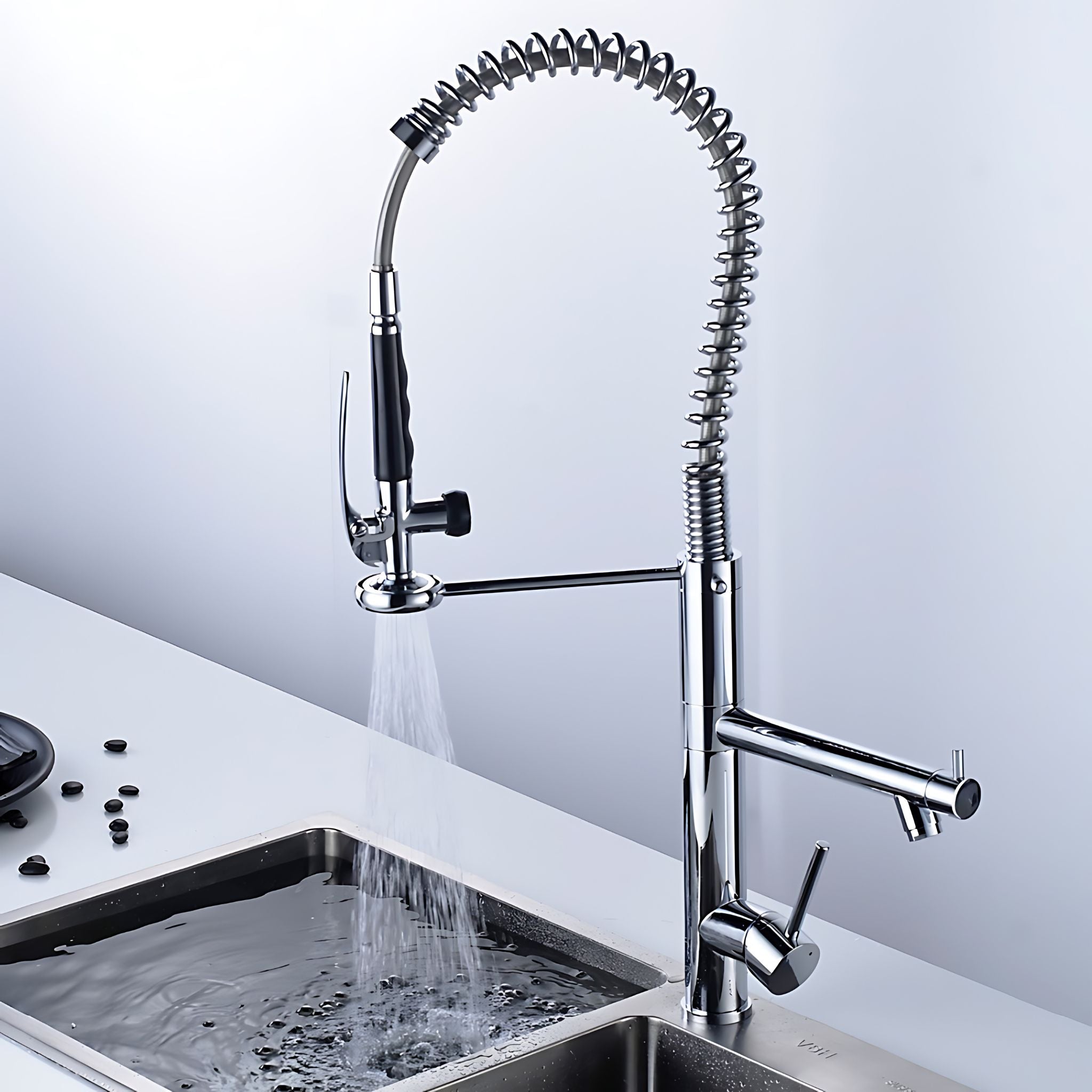 Chrome commercial kitchen faucet — pull-down sprayer directing water stream into double-basin sink #color_chrome