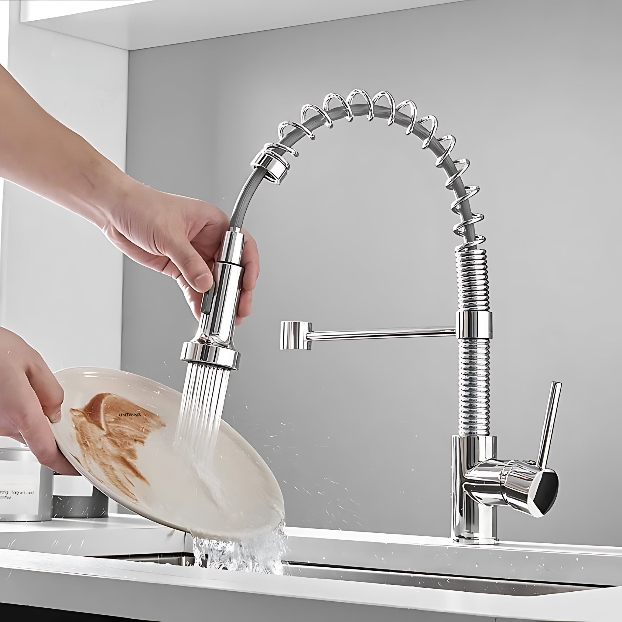 Hand rinsing a plate with the Spiro v2.0 chrome kitchen faucet sprayer in spray mode #color_chrome