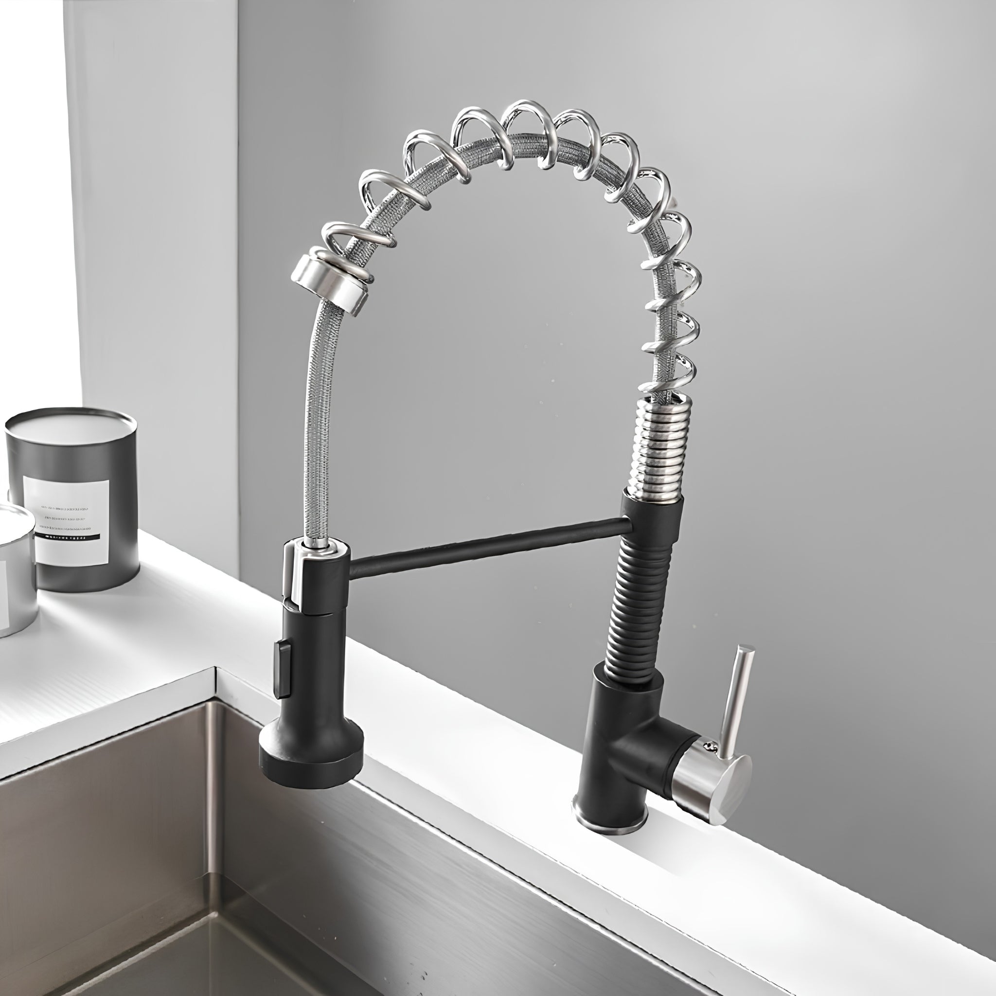 Spiro v2.0 matte black and brushed nickel spring spout kitchen faucet installed on a countertop above a stainless steel sink #color_matte black and brushed nickel